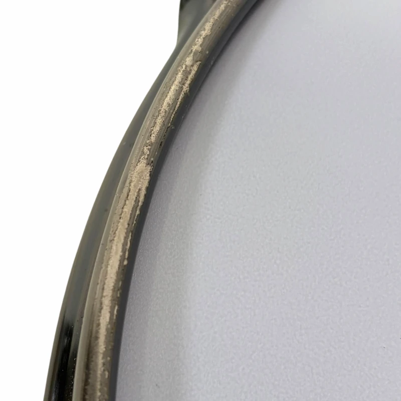 Close-up of a drum rim showing wear and tear, highlighting drum hardware details.