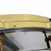 Close-up of a vintage snare drum with gold hardware and minor scratches.