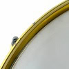 Close-up of a drum snare with gold hardware, highlighting the drum's detailed craftsmanship.