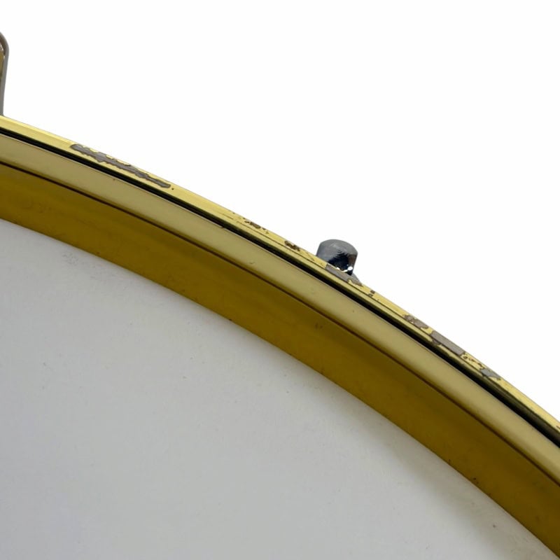 Close-up of a drum with yellow rim and drumstick holder, highlighting professional percussion equipm.