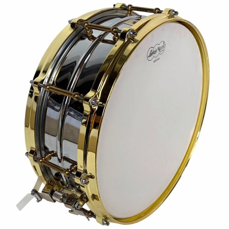 Snare drum with gold hardware, perfect for drummers, high-quality percussion instrument.