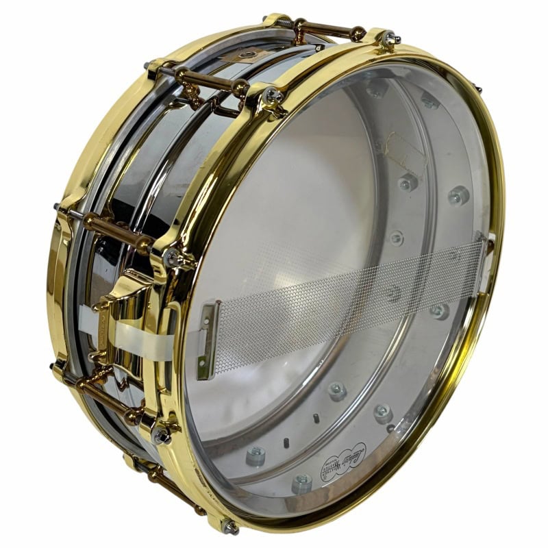Gold snare drum with transparent drumhead and metallic hardware.