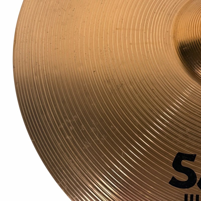 Gold drum cymbal with logo, close-up shot for drumming and percussion enthusiasts.