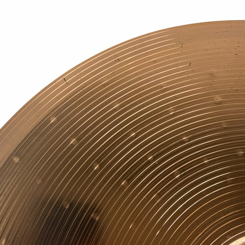 Cymbal close-up shot showcasing detailed concentric circles and metallic finish, ideal for drumming.