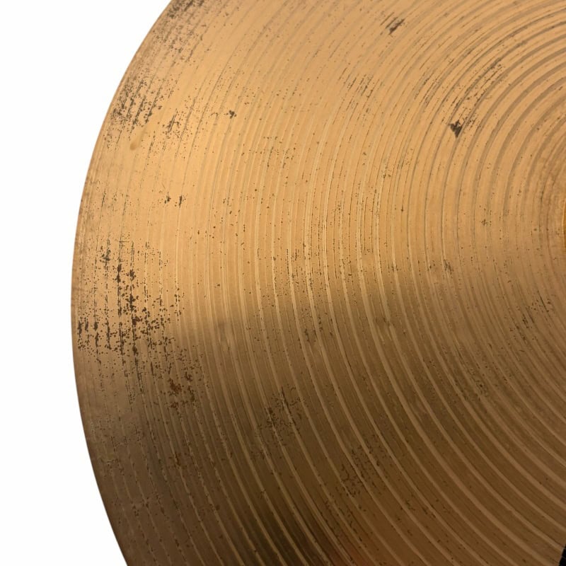 Close-up of a wooden drumstick with detailed grain and wear marks.