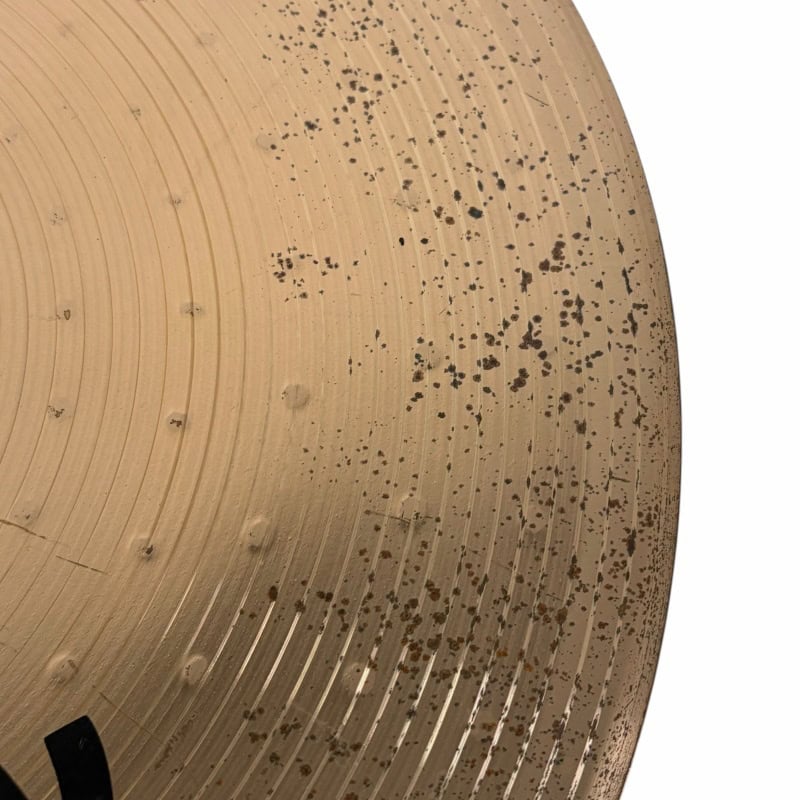 Vintage drum cymbal with patina and marks, showcasing its aged surface and unique character.