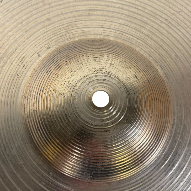 Close-up of a cymbal with concentric circles, representing drumming equipment.