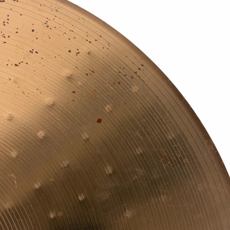 Close-up of a vintage snare drum with drumstick marks and rust spots, highlighting percussion instru.