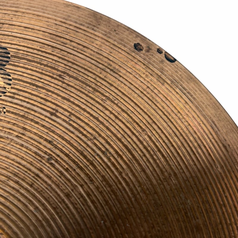 Close-up of a vintage cymbal with detailed grooves and patina, perfect for drummers and percussion e.
