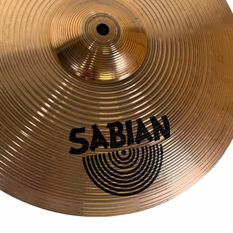 Close-up of Sabian cymbal showcasing intricate grooves and branding.
