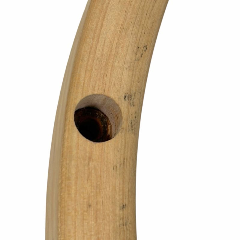 Close-up of wooden drumstick handle with a hole for grip.