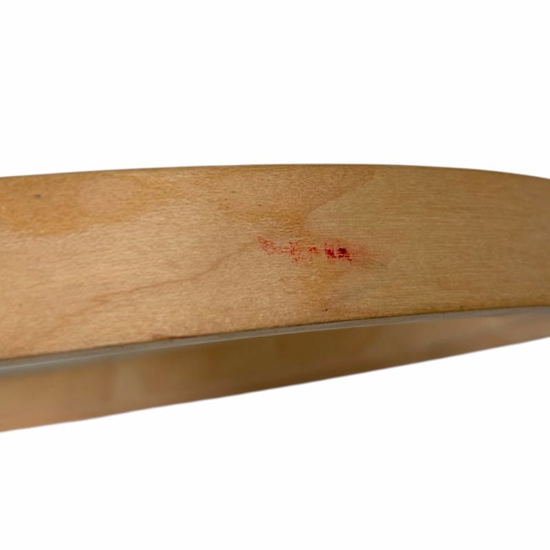 Close-up of wooden drumstick with minor wear, used for drumming practice or performance.