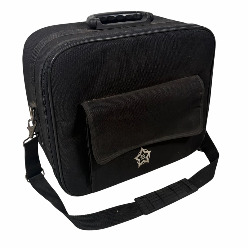 Black drumstick bag for drummers with adjustable strap and front pocket.