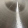 Close-up of a shiny metal drum surface with concentric circles, ideal for drumming and percussion.