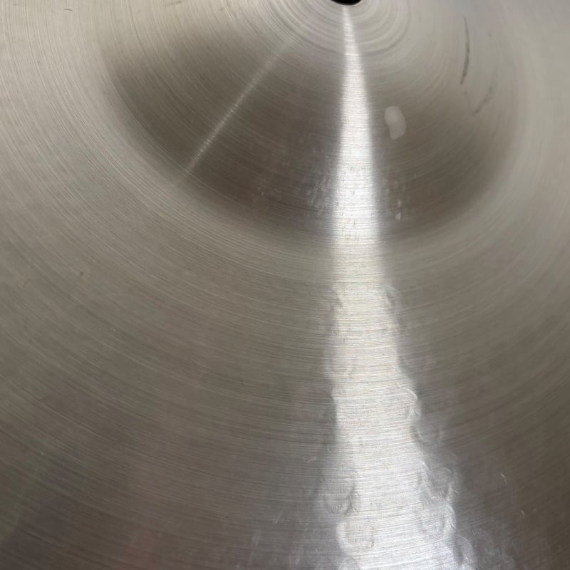 Close-up of a shiny metal drum surface with concentric circles, ideal for drumming and percussion.