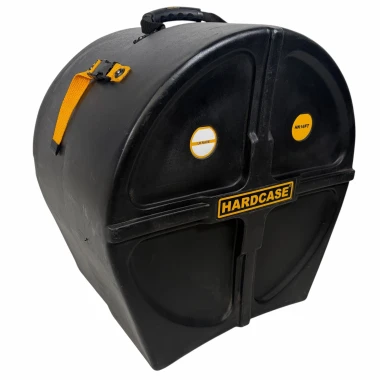 Heavy-duty black drum hardcase with yellow strap and handle for secure transport.
