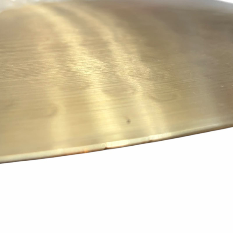 Brass drum cymbal with polished surface, ideal for percussion and drumming performances.
