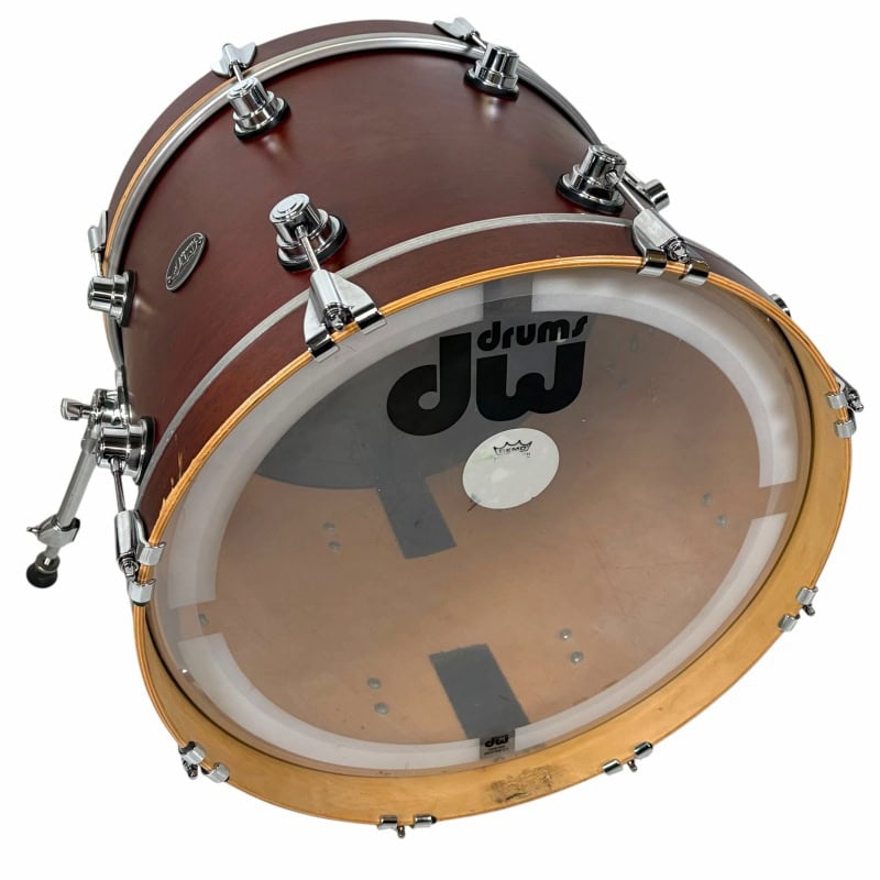 Drummers Only logo on bass drum with wooden finish and clear drumhead.
