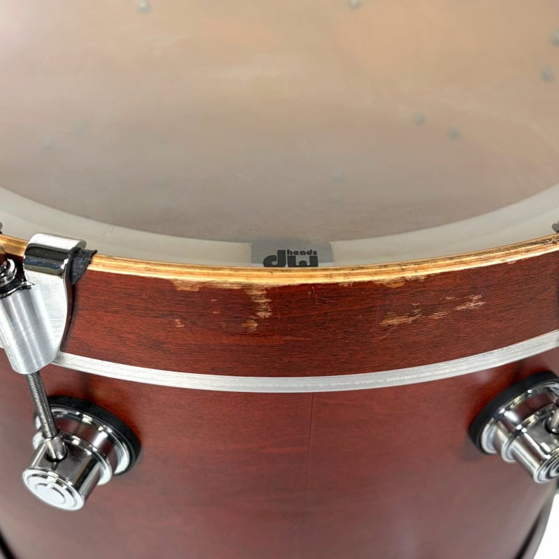 Vintage wooden drum kit with metal hardware, close-up shot.