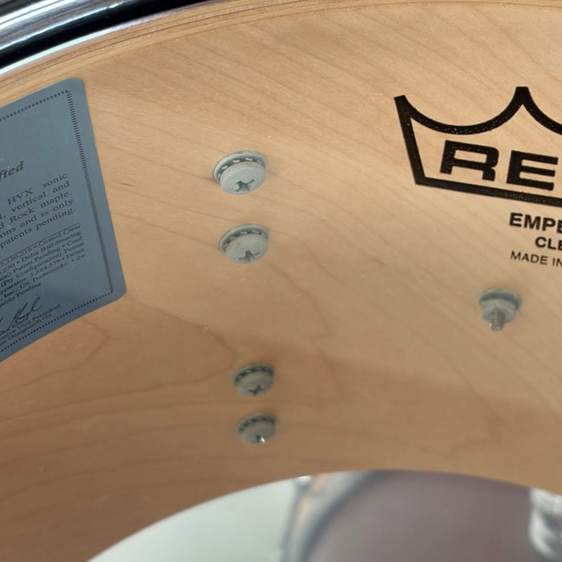 Drummers Only logo engraved on a wooden drum shell with visible screws.