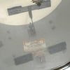 Close-up of Gretsch drum shell with badge and mounting hardware.