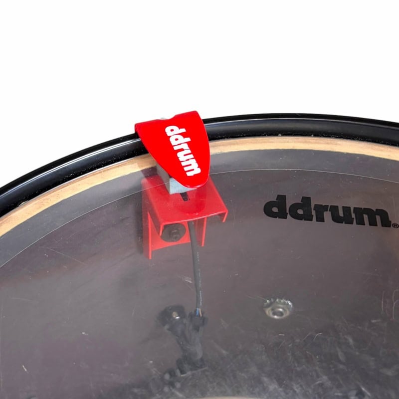 Close-up of a drum practice pad with drumstick and drumhead, ideal for drummers.