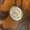 Close-up of Germany-made badge on wooden drum shell.
