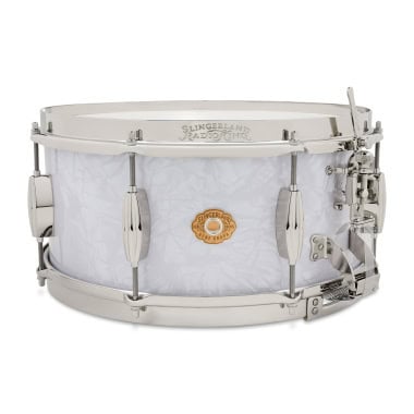 Snare drum with white finish, chrome hardware, and drumsticks, ideal for professional drummers and p.