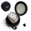Snare drum in protective case with drumsticks and accessories for drumming enthusiasts.