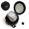Snare drum in protective case with drumsticks and accessories for drumming enthusiasts.