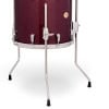 High-quality red snare drum with chrome hardware and sturdy stand.