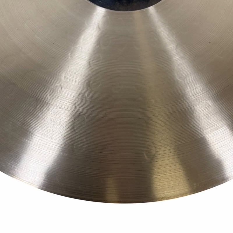 Close-up of Sabian HHX 21in Raw Bell Dry Ride cymbal surface details.