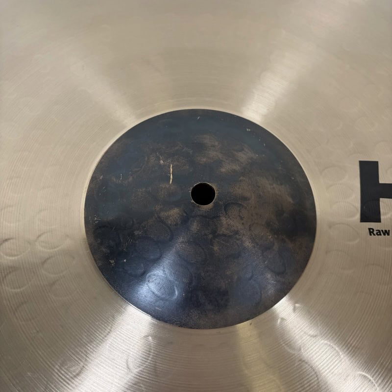 Close-up of Sabian HHX 21in Raw Bell Dry Ride cymbal surface details.