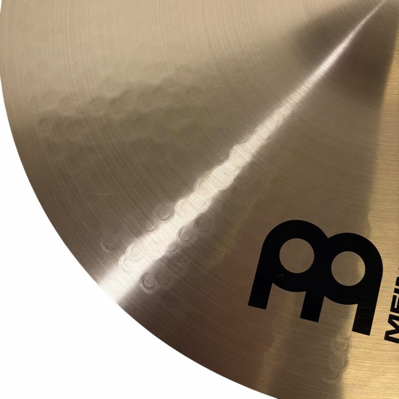 Close-up of Meinl 16-inch thin crash cymbal with logo and surface detail.
