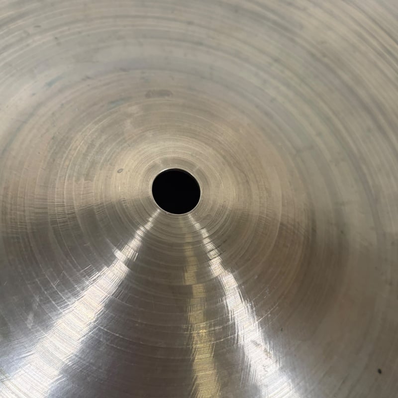 Close-up of a shiny 18-inch crash cymbal with concentric circles.