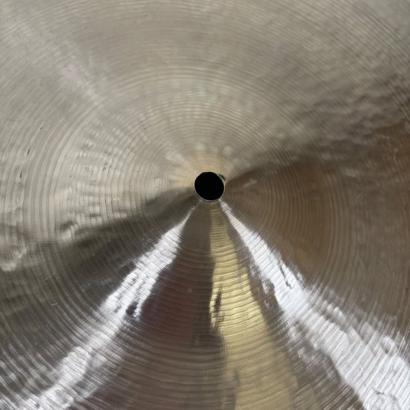 Close-up of Sabian 22in Artisan Ride cymbal with detailed surface texture.