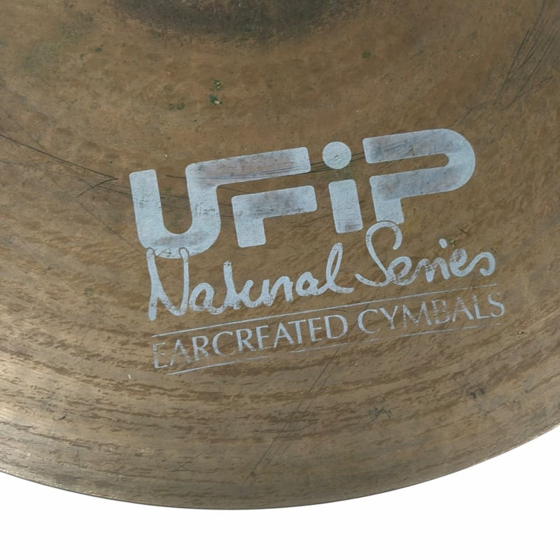 Close-up of UFIP Natural Series 22in ride cymbal with logo visible.