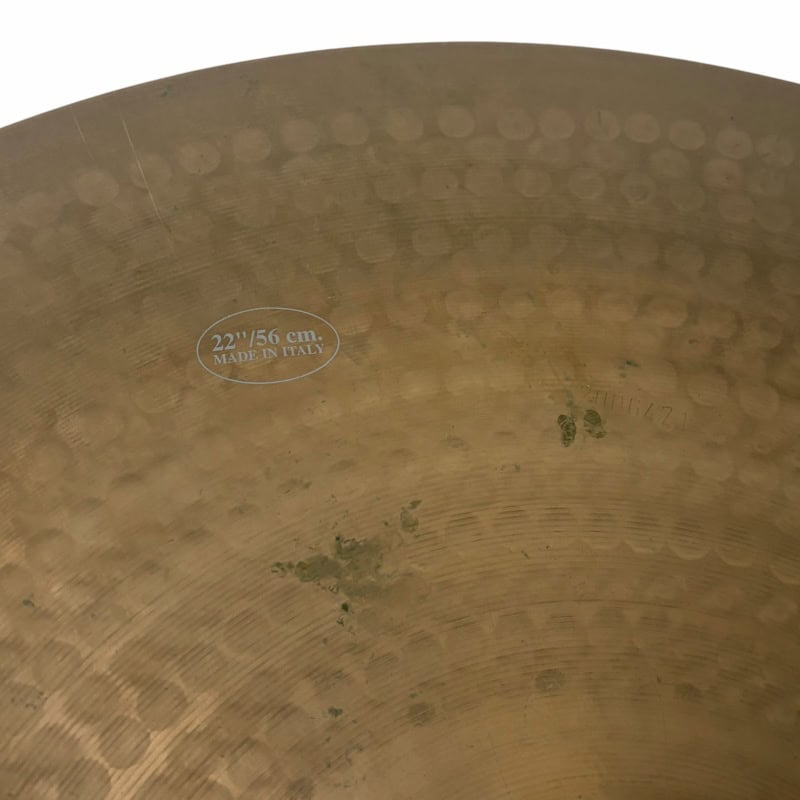 Close-up of a 22-inch UFIP Natural Series ride cymbal with patina and markings.