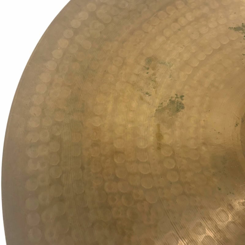 Close-up of a UFIP Natural Series 22in ride cymbal with detailed hammer marks.