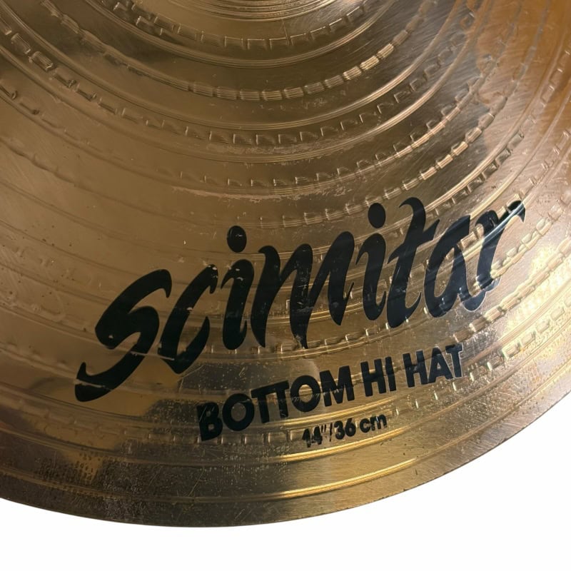 Close-up of Zildjian 14in Scimitar Hi-Hats with gold finish and black logo.