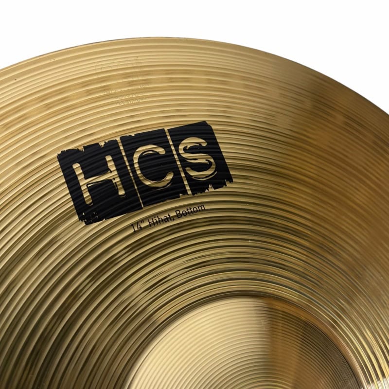 Close-up of Meinl HCS cymbal with logo and concentric grooves.