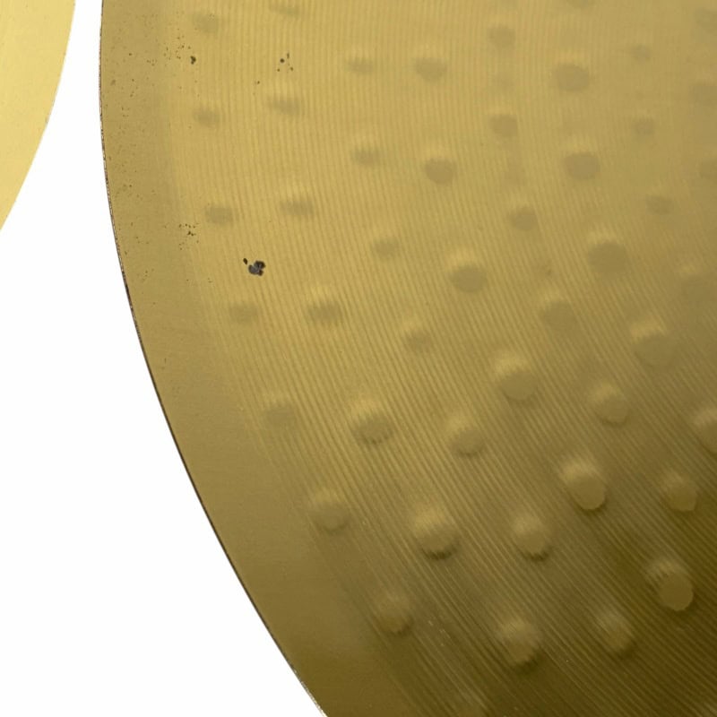 Close-up of Meinl HCS cymbal with textured surface and small dents.