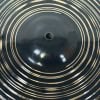 Close-up of a Meinl crash cymbal with concentric circles and a dark finish.