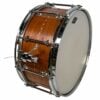 Wooden bass drum with chrome hardware for drumming performances.