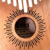 Close-up of Sela Kalimba thumb piano with wooden body and metal tines.