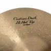 Close-up of a custom dark hi-hat top cymbal with branding.