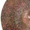 Close-up of a 16-inch dry crash cymbal with textured surface and patina.