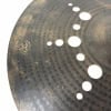 Close-up of Istanbul Xist 21in dark ride cymbal with holes and logo.