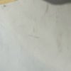 Plain white wall with small scratches and marks for background use.