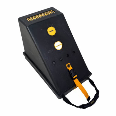 Durable black drum accessory case with yellow accents and strap for secure transport.